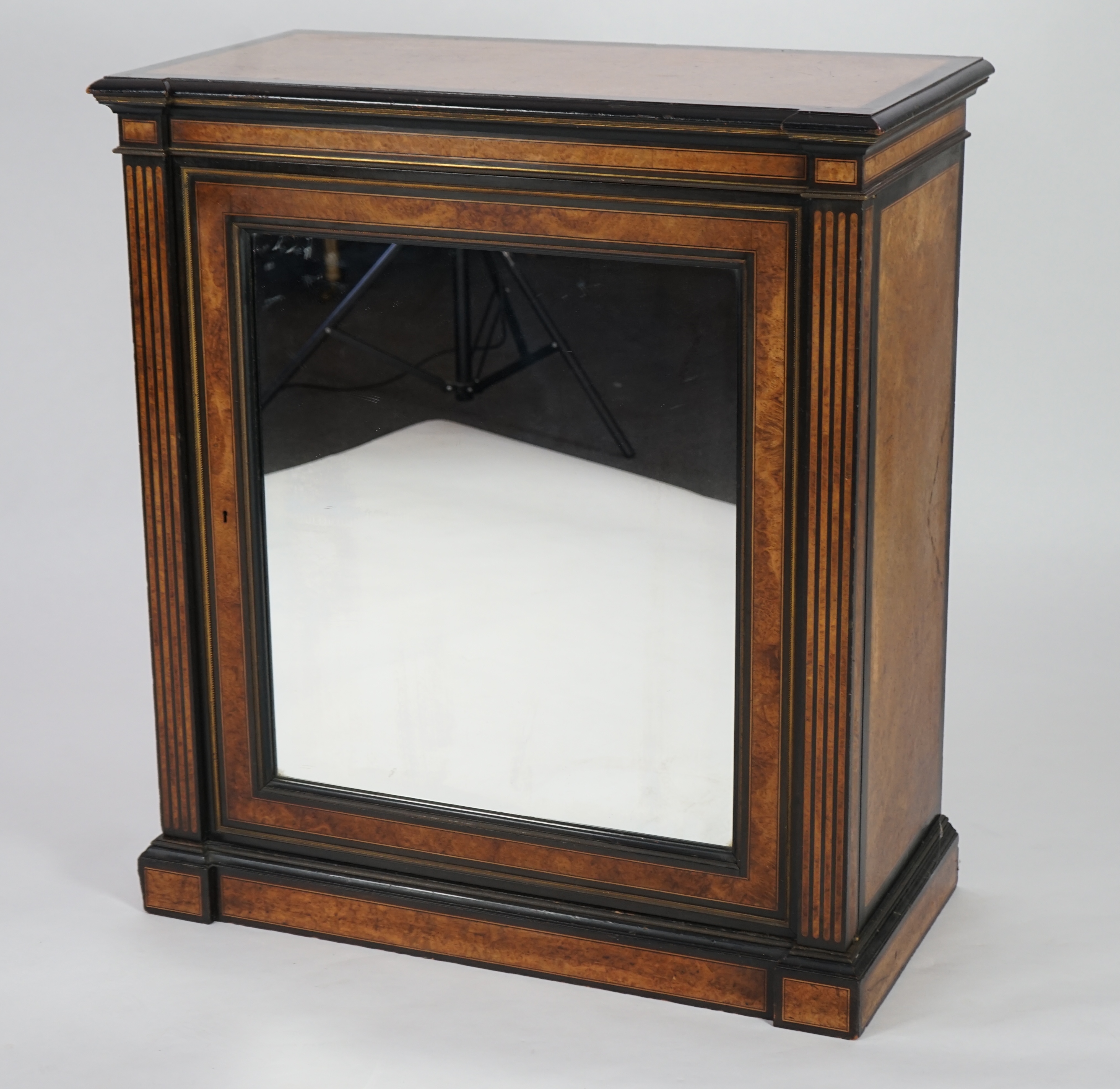 A Victorian ebony banded amboyna wood collector's cabinet, by Holland & Sons, with inverted breakfront top and single mirrored door enclosing four frieze and two banks of thirteen graduated drawers fitted with recessed b